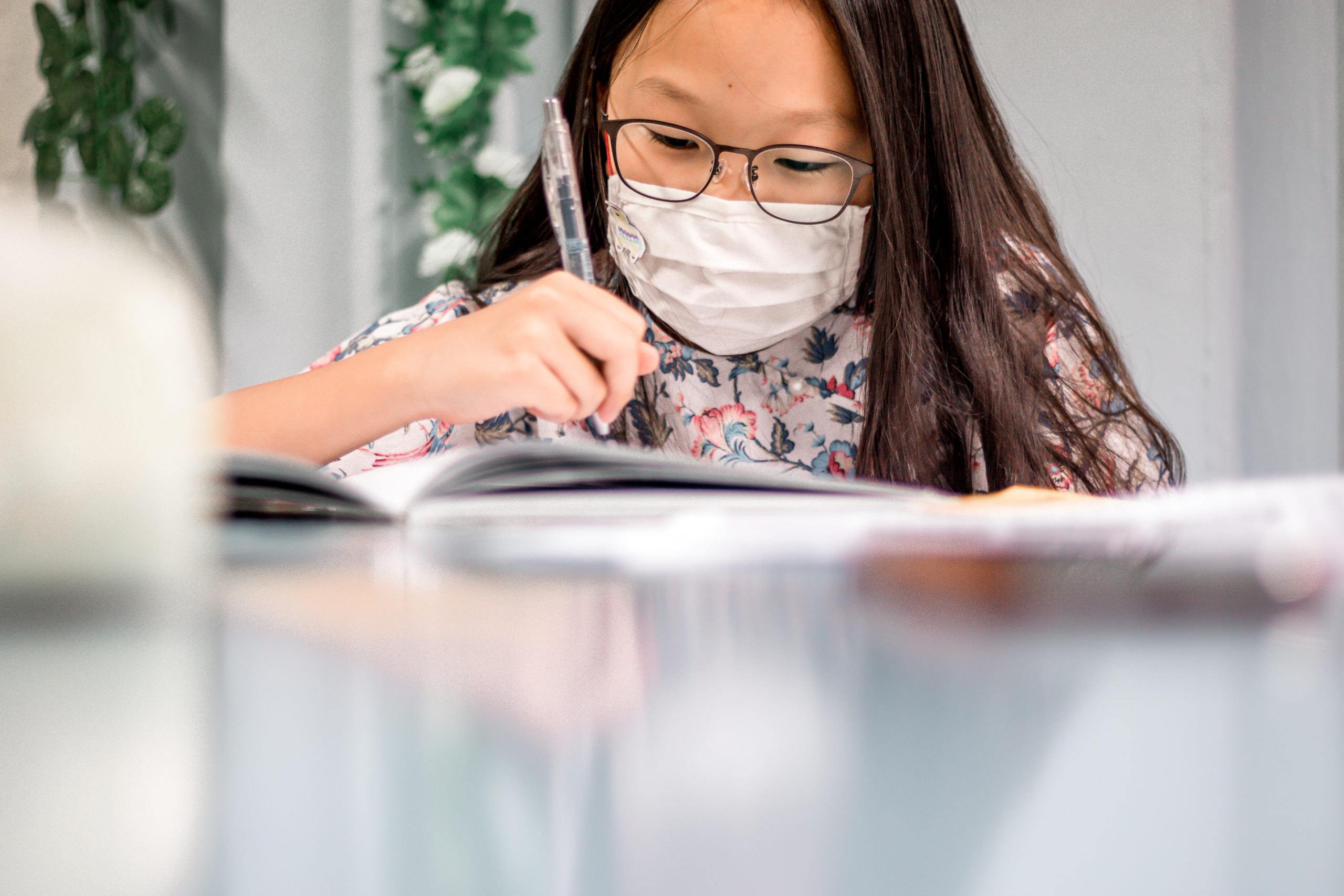 Close-up of an ASA student focusing on her written composition